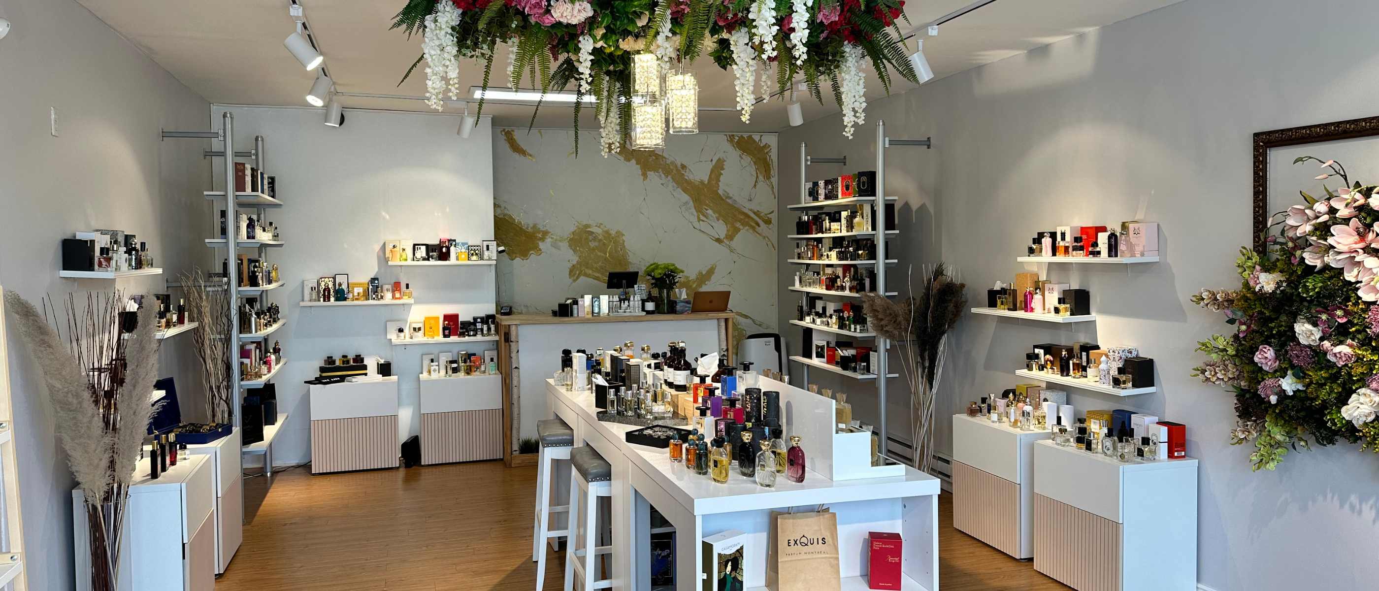 Interior view of Parfum Exquis store showcasing elegantly displayed perfume collection on wooden shelves, representing the wide variety of luxury fragrances available.